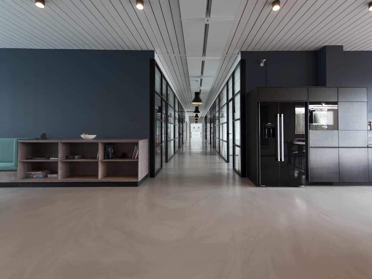 A clean, modern office interior with a lounge and pantry area